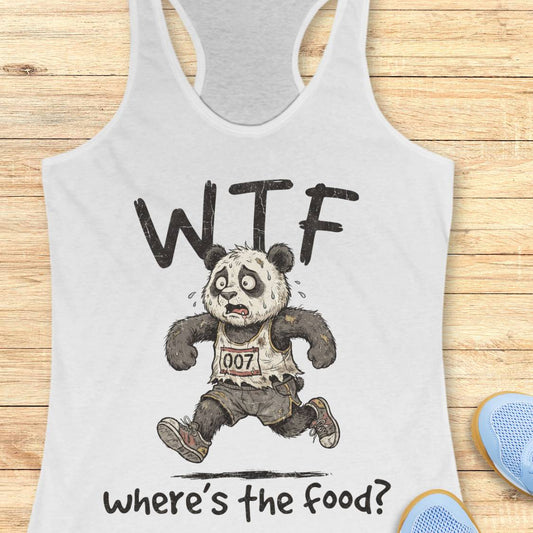 A white racerback tank top laid flat on a light wood surface, featuring a cartoon panda runner with the text 'WTF' above and 'where's the food?' below. Partial blue shoes are visible at the bottom right as styling props.