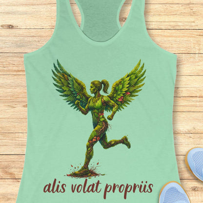 A mint green racerback tank top featuring a graphic of a winged female figure made of green leaves and vines, with the text 'alis volat propriis' printed below in dark red. The tank top is displayed flat on a light wood background.