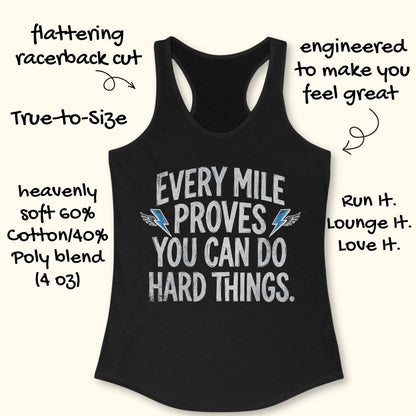 A black racerback tank top with a white graphic text reading 'EVERY MILE PROVES YOU CAN DO HARD THINGS' and small blue wing accents, shown on a light beige background with decorative handwritten callouts around it.