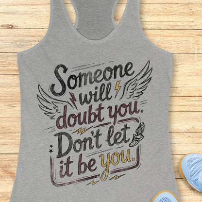 A heather gray racerback tank top with a motivational graphic reading 'Someone will doubt you. Don't let it be you.