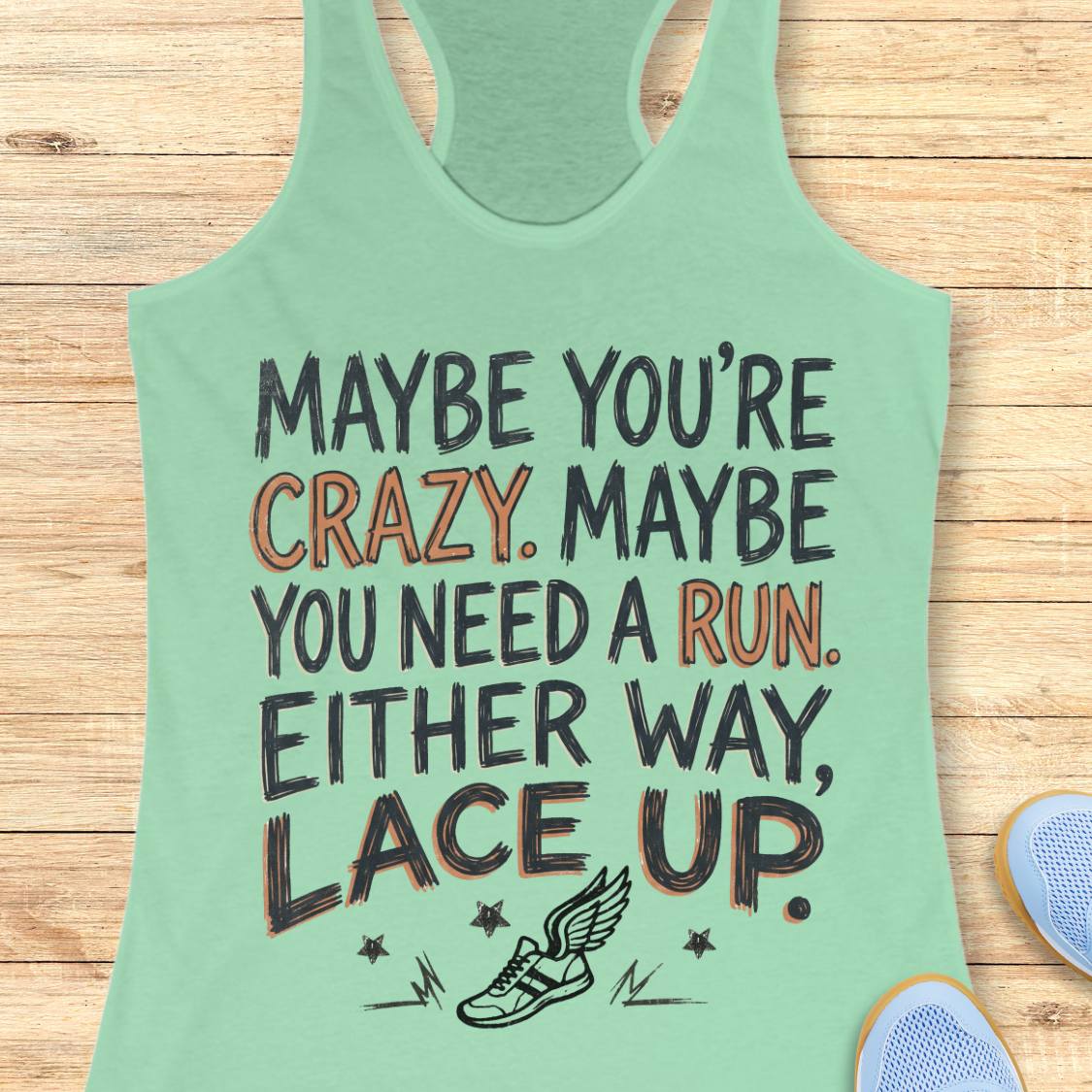 A mint green racerback tank top with a motivational graphic reading 'MAYBE YOU'RE CRAZY. MAYBE YOU NEED A RUN.