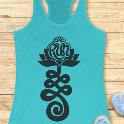 A turquoise racerback tank top with a black graphic of a lotus flower and the word 'Run' integrated into the petals, laid flat on a light wood background with partial sneakers visible at the bottom right.