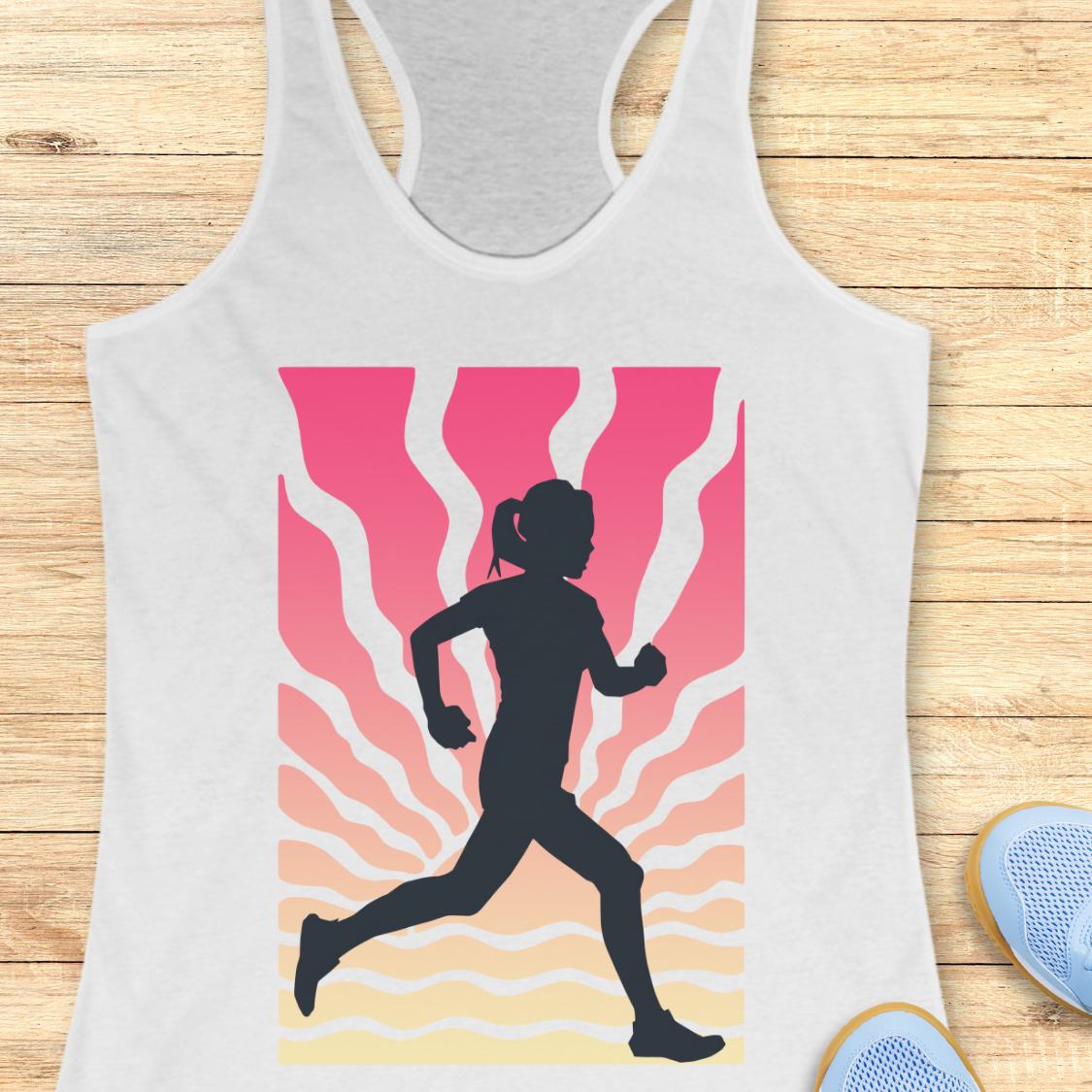 A white racerback tank top featuring a graphic print of a black silhouette runner against a pink, orange, and yellow wavy background, displayed on a light wood plank surface.
