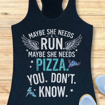 A navy racerback tank top laid flat on a light wood background, printed with the phrase “MAYBE SHE NEEDS A RUN. MAYBE SHE NEEDS PIZZA.