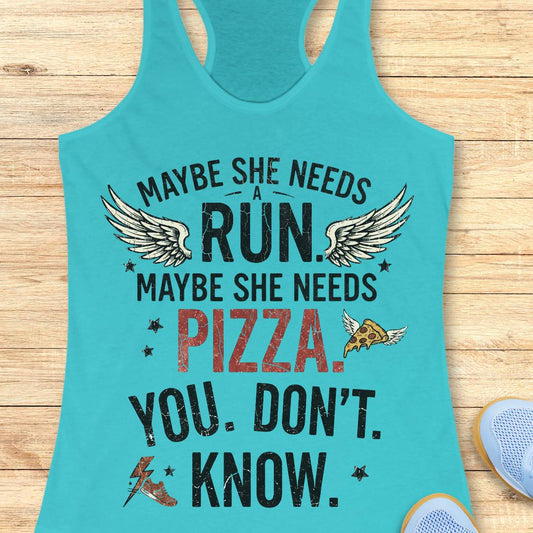 A turquoise racerback tank top laid flat on a light wood surface, featuring a distressed graphic that reads 'MAYBE SHE NEEDS A RUN. MAYBE SHE NEEDS PIZZA.