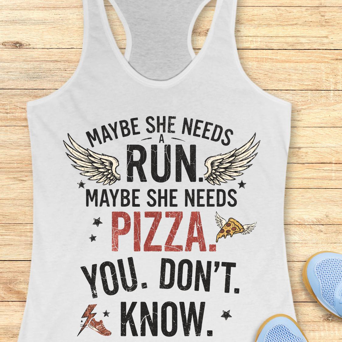 A white racerback tank top laid flat on a light wood background, printed with the phrase “MAYBE SHE NEEDS A RUN. MAYBE SHE NEEDS PIZZA.