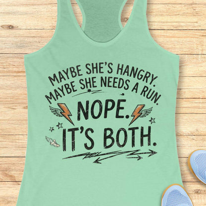 A mint racerback tank top laid flat on a light wood surface, featuring a humorous white graphic text that reads 'MAYBE SHE'S HANGRY. MAYBE SHE NEEDS A RUN.