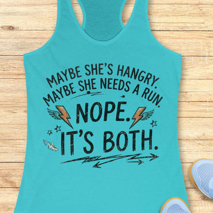 A turquoise racerback tank top laid flat on a light wood floor, featuring a humorous graphic that reads 'MAYBE SHE'S HANGRY. MAYBE SHE NEEDS A RUN.