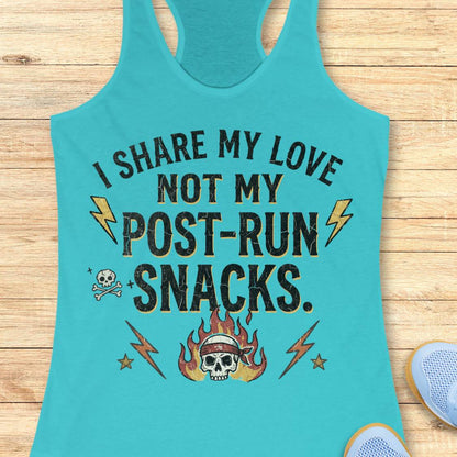 A turquoise racerback tank top laid flat on a light wood surface, featuring the printed phrase 'I SHARE MY LOVE NOT MY POST-RUN SNACKS.' in black with yellow lightning bolts, a small skull graphic, and a flaming skull at the bottom.