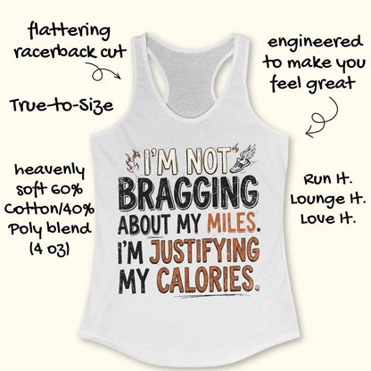 A  white racerback tank top featuring  the text 'I'm not bragging about my miles. I'm justifying my calories' printed on the front, displayed flat on a light wood background.