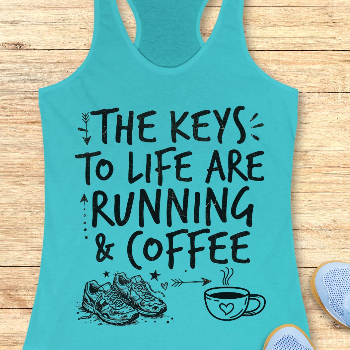 A turquoise racerback tank top laid flat on a light wood background, featuring the black printed text 'THE KEYS TO LIFE ARE RUNNING & COFFEE' with small running shoes and a coffee cup illustration below.