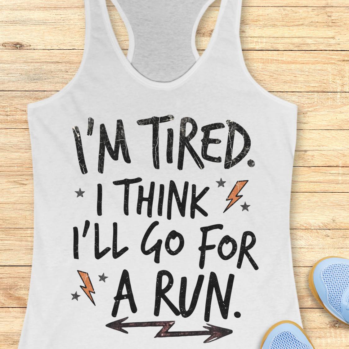 A white racerback tank top with a humorous motivational graphic that reads 'I'M TIRED. I THINK I'LL GO FOR A RUN.