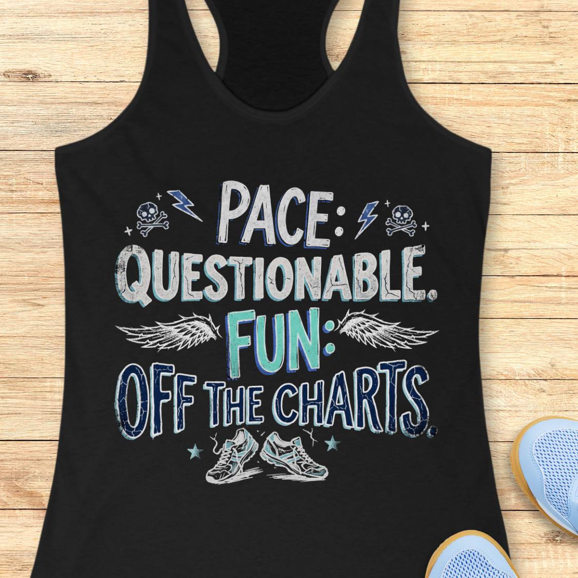 A black racerback tank top laid flat on a light wood surface, featuring a distressed graphic that reads 'PACE: QUESTIONABLE. FUN: OFF THE CHARTS.