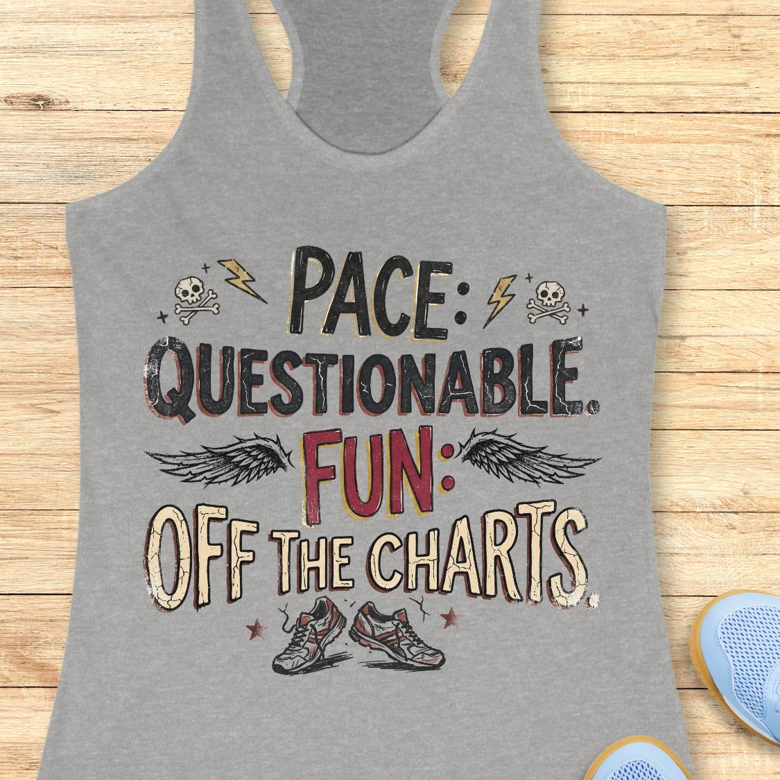 A heather gray racerback tank top laid flat on a light wood background, featuring a distressed graphic that reads 'PACE: QUESTIONABLE. FUN: OFF THE CHARTS.