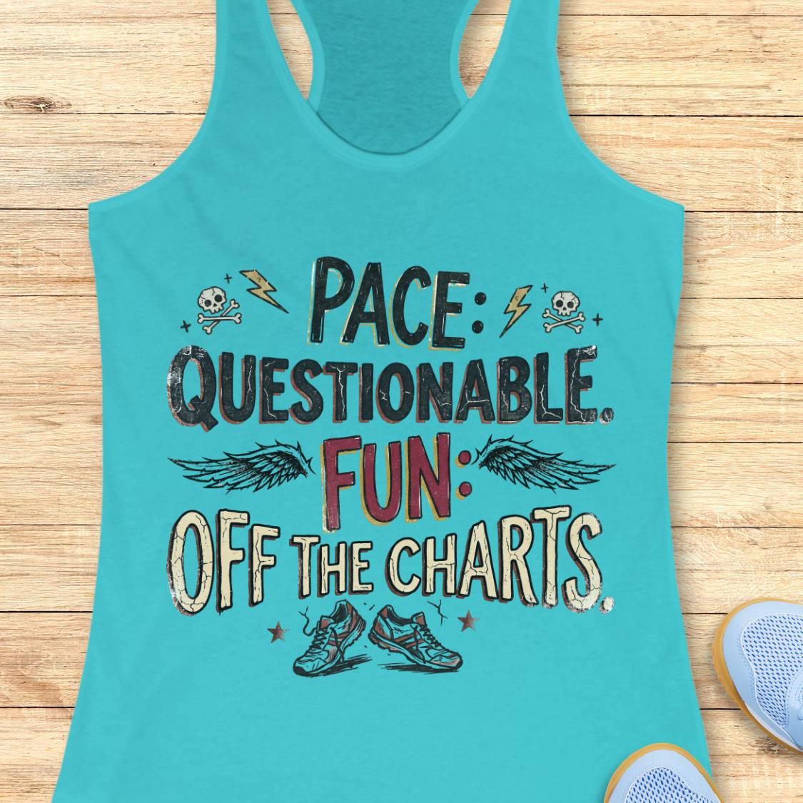 A turquoise racerback tank top laid flat on a light wood background, featuring a distressed graphic that reads 'PACE: QUESTIONABLE. FUN: OFF THE CHARTS.