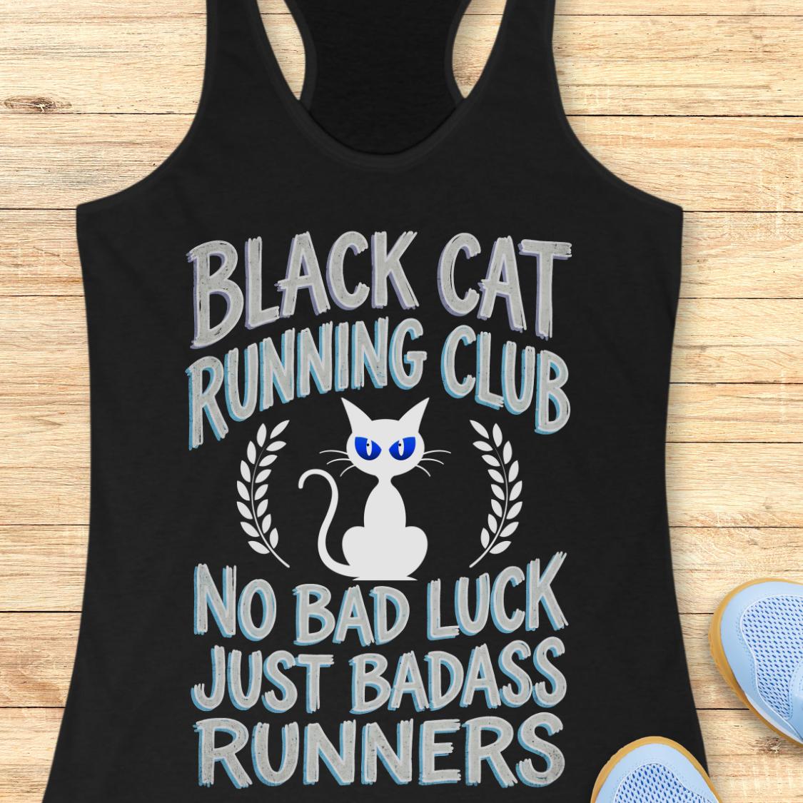 A black racerback tank top laid flat on a light wood background, featuring a graphic design with the text 'BLACK CAT RUNNING CLUB' and 'NO BAD LUCK JUST BADASS RUNNERS' around a white cat illustration with blue eyes.