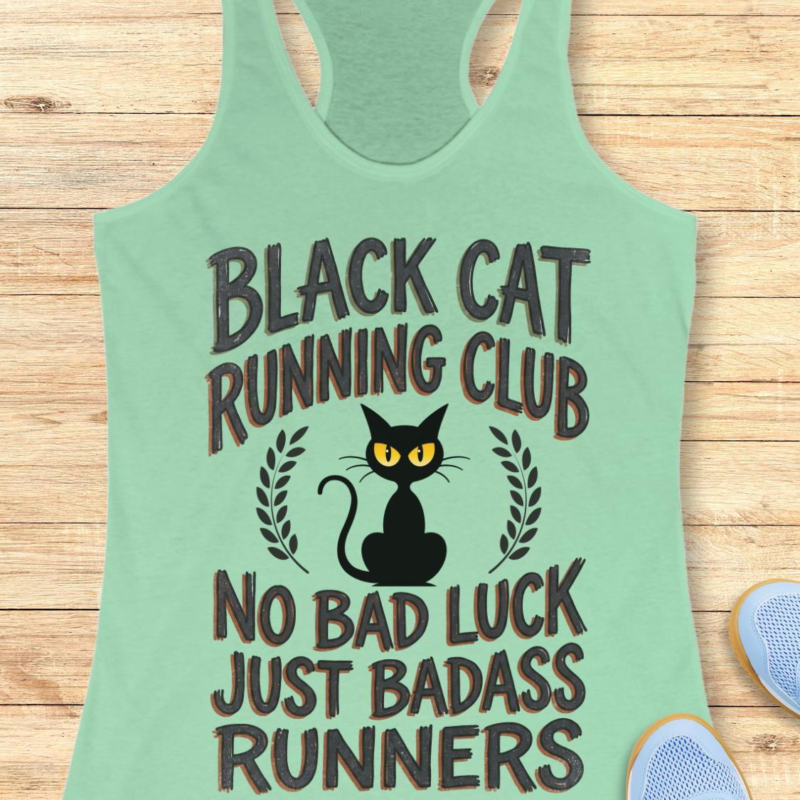 A mint green racerback tank top laid flat on a light wood background, featuring a graphic of a black cat with yellow eyes and the text 'BLACK CAT RUNNING CLUB' and 'NO BAD LUCK JUST BADASS RUNNERS'.
