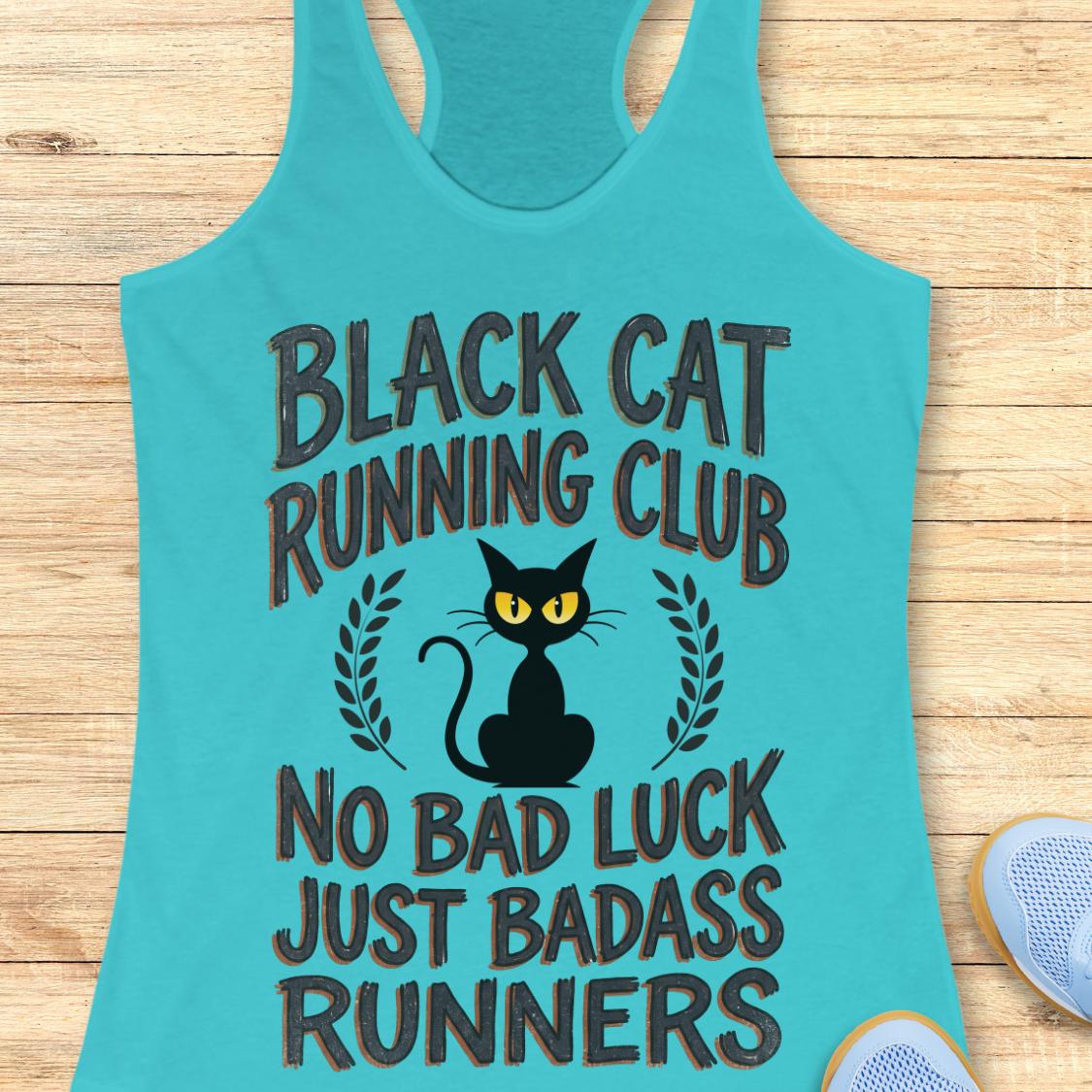 A turquoise racerback tank top laid flat on a light wood surface, featuring a black cat graphic with yellow eyes and the text 'BLACK CAT RUNNING CLUB NO BAD LUCK JUST BADASS RUNNERS.' A partial light blue shoe is visible at the lower right edge.