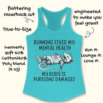 A turquoise racerback tank top laid flat on a light beige background with handwritten marketing text around it. The shirt has a large black-and-white illustration of a raccoon wearing a 'PT' shirt and the slogan 'RUNNING FIXED MY MENTAL HEALTH MY BODY IS PURSUING DAMAGES'.