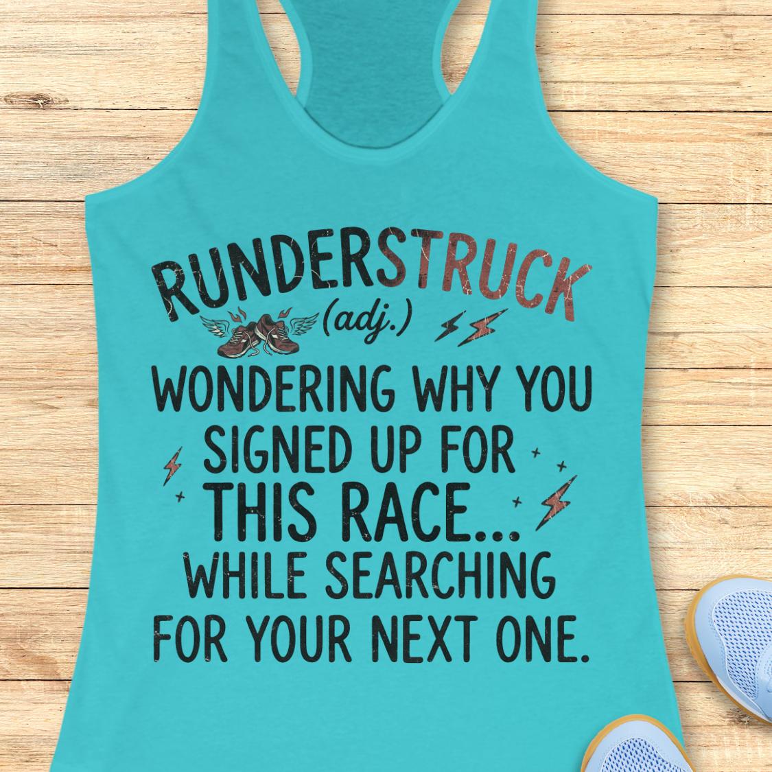 A turquoise racerback tank top laid flat on a light wood background, featuring a humorous printed race slogan in black and reddish-orange text with small shoe and lightning bolt graphics.