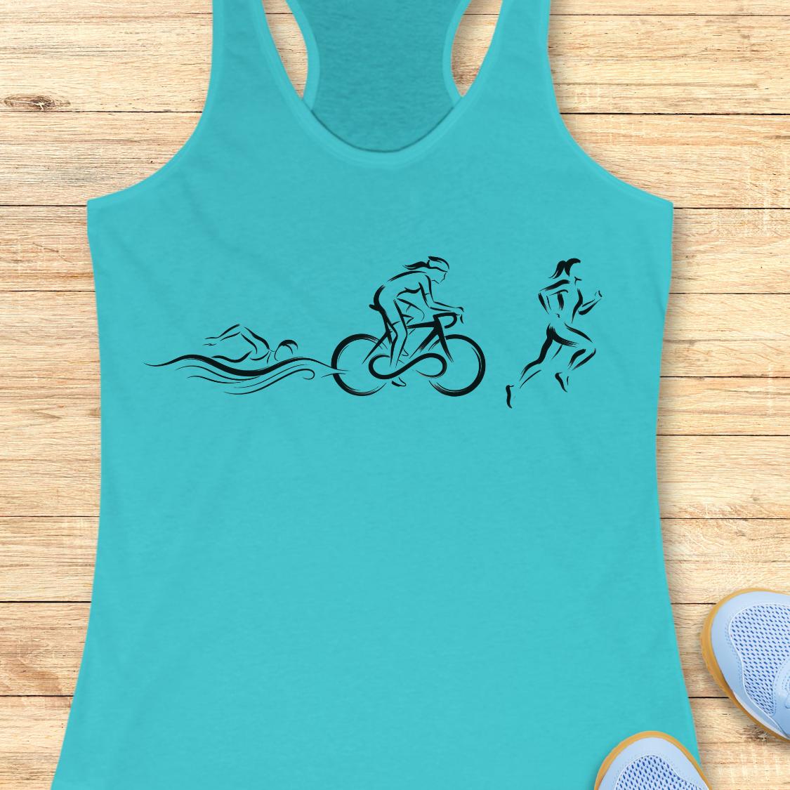 A turquoise racerback tank top with a black graphic of a swimmer, cyclist, and runner, laid flat on a light wood plank background.