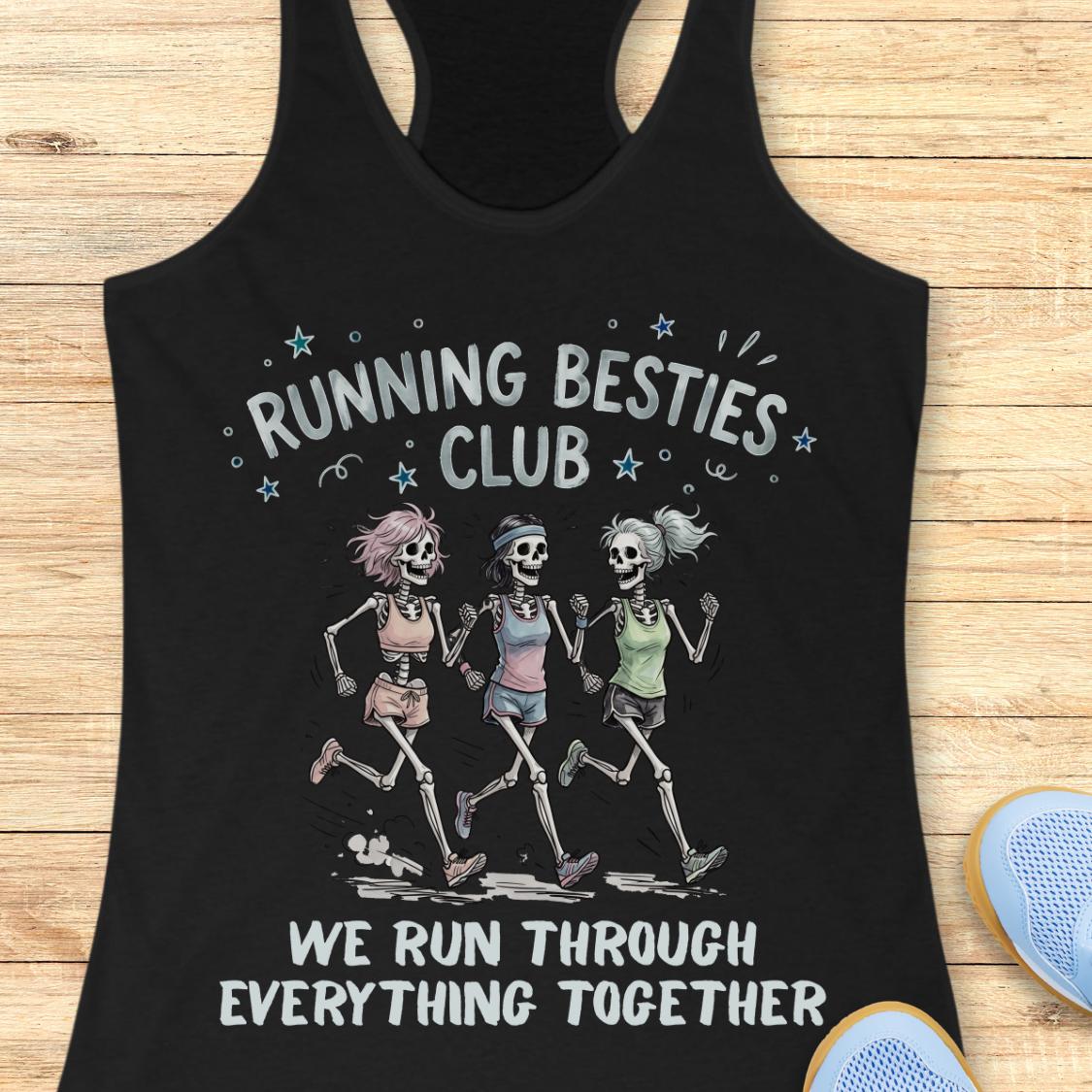 A black racerback tank top laid flat on a light wood surface, featuring a graphic of three running skeletons with the text 'RUNNING BESTIES CLUB' and 'WE RUN THROUGH EVERYTHING TOGETHER.' A blue shoe is partially visible at the bottom right as a styling prop.