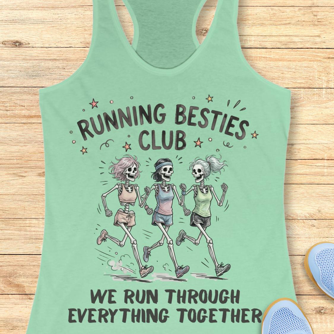A mint green racerback tank top laid flat on a light wood background, featuring a graphic of three running skeleton women with the text 'RUNNING BESTIES CLUB' and 'WE RUN THROUGH EVERYTHING TOGETHER'.