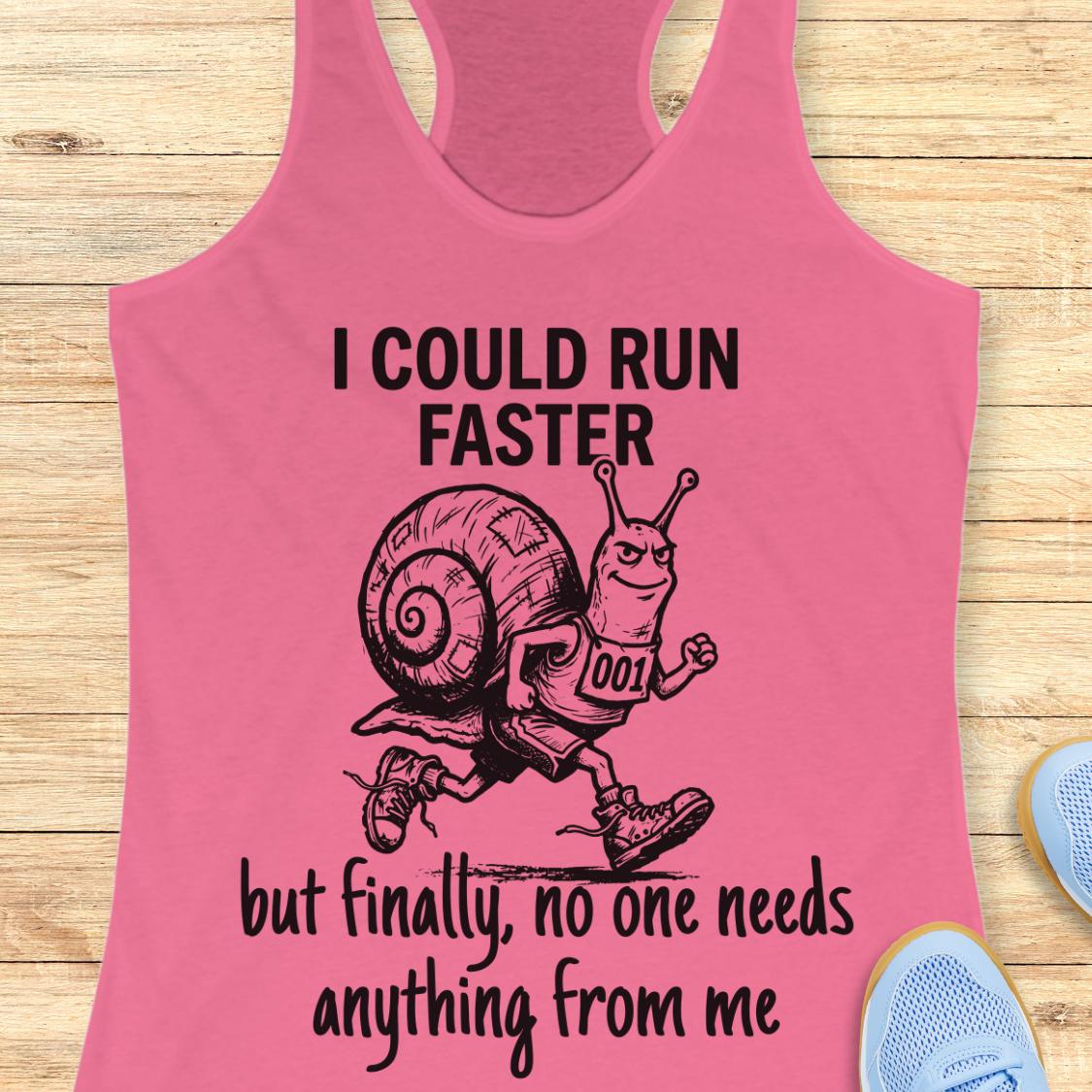A pink racerback tank top laid flat on a light wood background, featuring a black graphic of a snail running with the text 'I COULD RUN FASTER but finally, no one needs anything from me'.