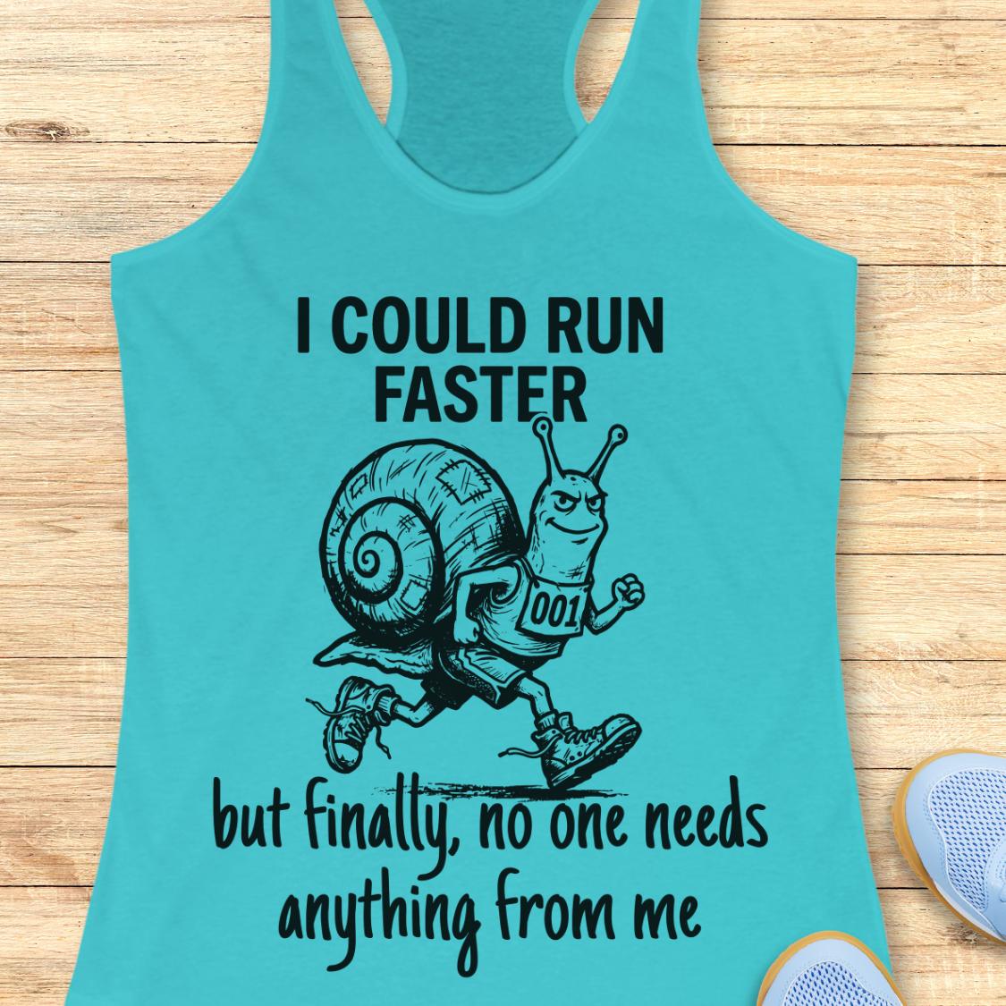A turquoise racerback tank top laid flat on a light wood surface, featuring a black graphic of a cartoon snail running with the text 'I COULD RUN FASTER but finally, no one needs anything from me.' Partial white sneakers are visible at the bottom right edge.