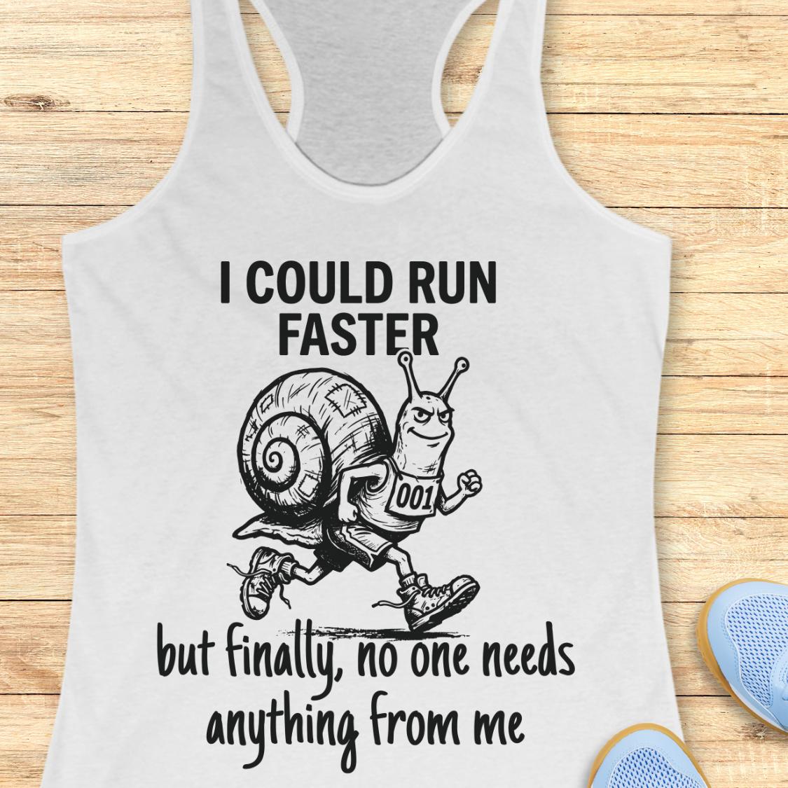 A white racerback tank top with a black graphic of a snail running and the text 'I COULD RUN FASTER but finally, no one needs anything from me', shown on a wooden background with blue shoes partially visible in the corner.