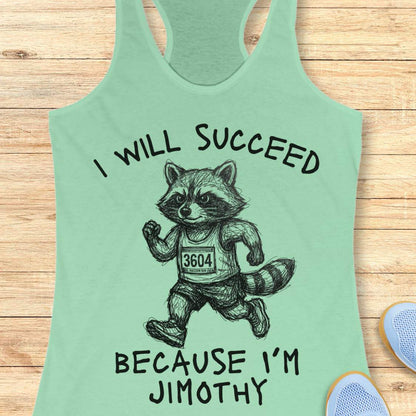A mint green racerback tank top laid flat on a light wood background, featuring a black graphic of a raccoon running with the text 'I WILL SUCCEED BECAUSE I'M JIMOTHY'.