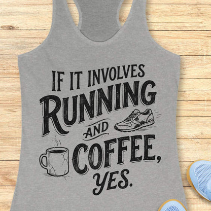 A heather gray racerback tank top with a black graphic print reading 'IF IT INVOLVES RUNNING AND COFFEE, YES.' with a coffee mug, running shoe, and bold lettering, shown on a light wood plank background.