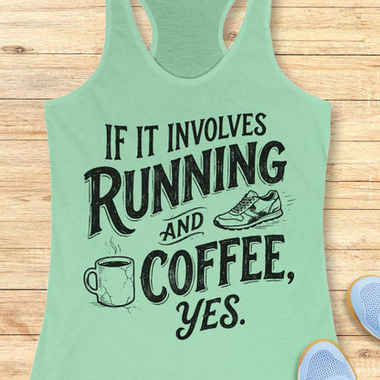 A mint green racerback tank top with a black graphic text print reading 'IF IT INVOLVES RUNNING AND COFFEE, YES.' displayed flat on a light wood background with partial sneakers visible at the edges.