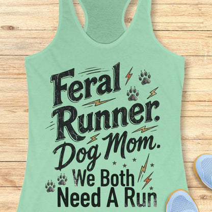 A mint green racerback tank top with a distressed black graphic that reads 'Feral Runner. Dog Mom.