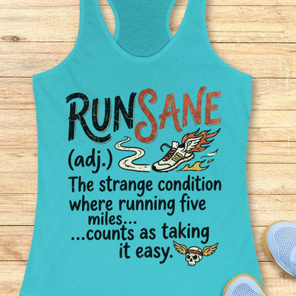 A turquoise racerback tank top laid flat on a light wood background, featuring a humorous graphic that reads 'RUN SANE (adj.) The strange condition where running five miles .