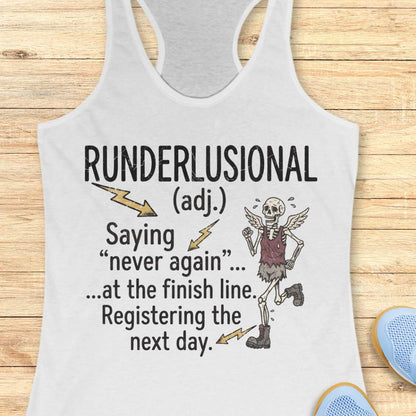 A white racerback tank top laid flat on a light wood background, featuring a humorous graphic that reads 'RUNDERLUSIONAL (adj.) Saying "never again" .