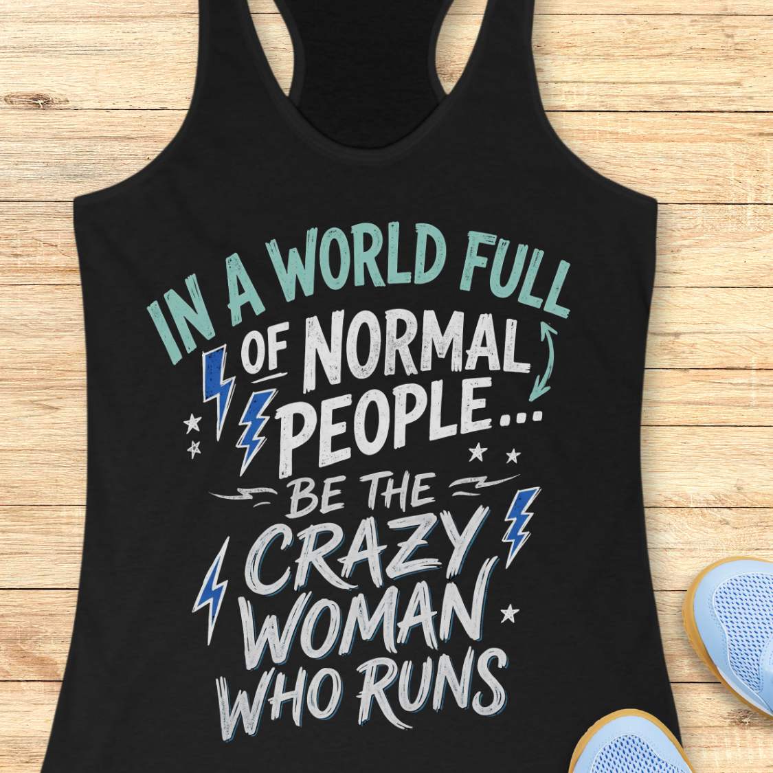 A black racerback tank top with a graphic text print reading 'IN A WORLD FULL OF NORMAL PEOPLE.