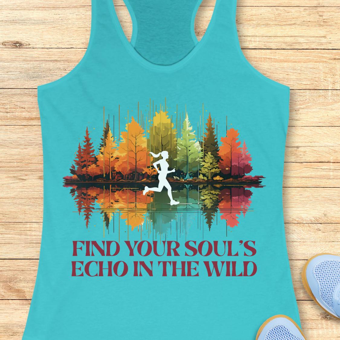 A turquoise racerback tank top laid flat on a light wood surface, featuring a colorful forest graphic with a white running silhouette and the text 'FIND YOUR SOUL'S ECHO IN THE WILD' in dark red. Part of a blue shoe is visible at the bottom right.