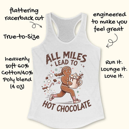 white running tank top featuring a cartoon gingerbread runner carrying a steaming mug of hot chocolate topped with marshmallows. Chocolate pieces, marshmallows, candy canes, and winter-themed accents surround the character. The design includes the phrase 'ALL MILES LEAD TO HOT CHOCOLATE.