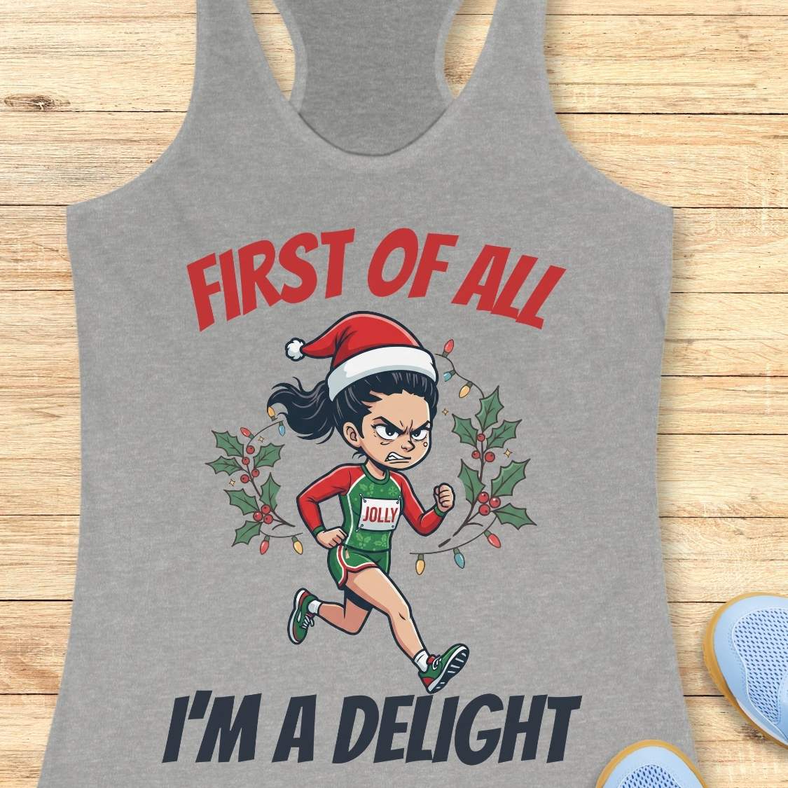 grey running tank top featuring a cartoon holiday runner wearing a Santa hat and a race singlet labeled 'JOLLY.' The runner is surrounded by holly leaves and colorful Christmas lights. The design includes the phrase 'FIRST OF ALL I'M A DELIGHT.'