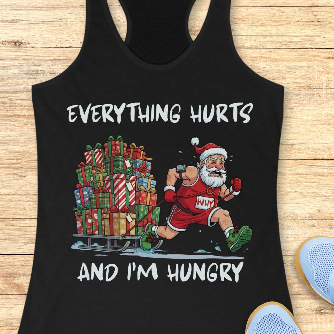 Funny Christmas running design on a black tank top featuring a cartoon Santa Claus running while pulling a sled piled high with wrapped Christmas presents. Bold black text above and below the illustration reads: "EVERYTHING HURTS AND I'M HUNGRY." The festive artwork combines holiday humor with running and fitness themes.
