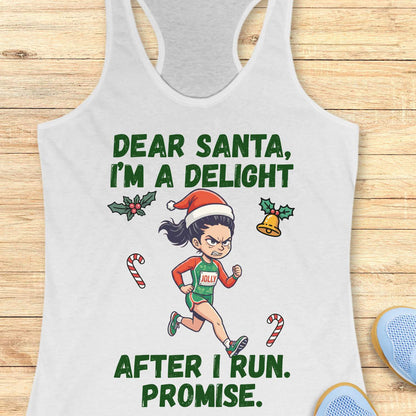 white racerback tank top displayed on a light wooden surface, featuring a festive running-themed graphic. The design shows a cartoon runner wearing a Santa hat, green running outfit with the word “JOLLY” on the chest, and running shoes. Holiday elements including holly leaves, a Christmas bell, and candy canes surround the runner. Bold green text above and below the illustration reads: “DEAR SANTA, I’M A DELIGHT” and “AFTER I RUN. PROMISE.” Partial blue athletic shoes are visible in the lower corner