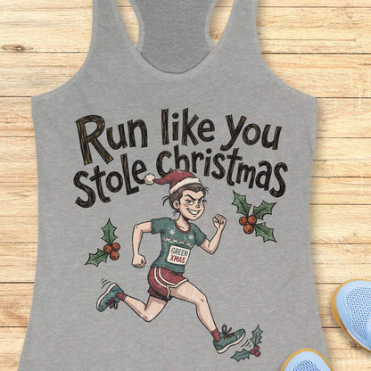 grey racerback tank top featuring the playful Christmas running phrase "Run Like You Stole Christmas" in large black lettering. Below the text is a cartoon runner wearing a Santa hat, holiday-themed running outfit, and a race bib that reads "GREEN XMAS." The runner is shown sprinting forward with a mischievous holiday vibe, surrounded by holly leaves and red berries. The festive design combines Christmas humor and running culture, making it perfect for runners who love holiday races, ugly sweater seas