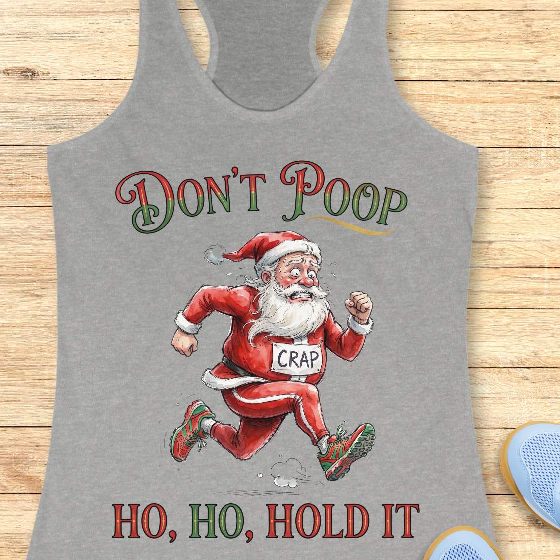 grey racerback tank top featuring the funny Christmas running phrase “DON’T POOP HO, HO, HOLD IT” in festive red and green lettering. The design shows a cartoon Santa Claus running urgently in athletic shoes while wearing a race bib labeled “CRAP.” Santa appears mid-stride with a humorous expression, creating a playful nod to the well-known runner's struggle of finding a bathroom during a race. This lighthearted holiday running design is perfect for runners who appreciate race-day humor and Christmas-theme