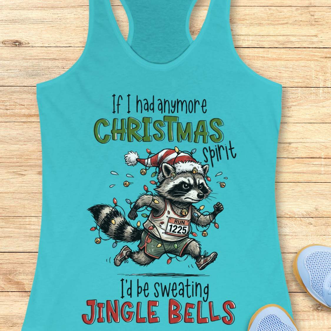 blue racerback tank top featuring the humorous Christmas running quote “If I had anymore Christmas spirit I’d be sweating Jingle Bells.” The design shows a cartoon raccoon runner wearing a Santa hat and wrapped in colorful Christmas lights while running in athletic gear. The raccoon wears a race bib labeled “RUN 1225” and is surrounded by festive holiday lights and jingle bells. The playful artwork combines Christmas cheer, running humor, and woodland charm, making it perfect for runners who love holiday r
