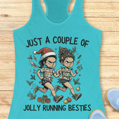 blue racerback running tank top displayed on a wooden background featuring a festive illustration of two runners in holiday outfits. One runner wears a Santa hat and the other wears reindeer antlers adorned with Christmas decorations. The runners are dressed in race gear, surrounded by holly, ornaments, presents, and holiday accents. The design includes the text: “JUST A COUPLE OF JOLLY RUNNING BESTIES.” Blue running shoes are partially visible at the bottom corners of the image.