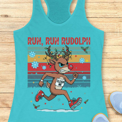 A blue racerback tank top with a colorful 'RUN, RUN RUDOLPH' holiday graphic on the front, shown on a light beige background with decorative text callouts around it.