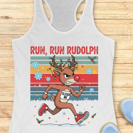 A white racerback tank top with a colorful 'RUN, RUN RUDOLPH' holiday graphic on the front, shown on a light beige background with decorative text callouts around it.