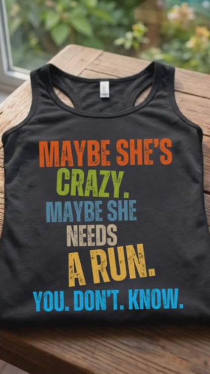 A video with a Black women runner tank top with a funny colorful text 'Maybe she's crazy. Maybe she needs a run. you. don't. know.', on a wooden surface