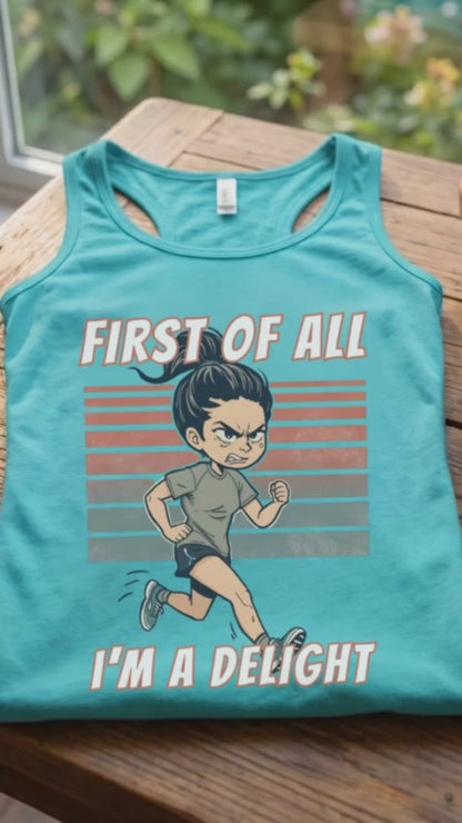 A video of a women runner turquoise tank top laid flat on a wooden table, featuring a cartoon running man graphic with the text 'FIRST OF ALL I'M A DELIGHT'. A ceramic mug of coffee and a small potted succulent sit beside it, with a window and garden visible in the background.